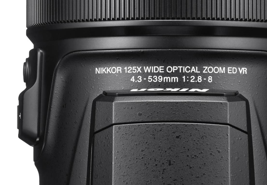 Close-up of the Nikon P1000 lens barrel marked NIKKOR 125x wide optical zoom 4.3-539mm 1:2.8-8