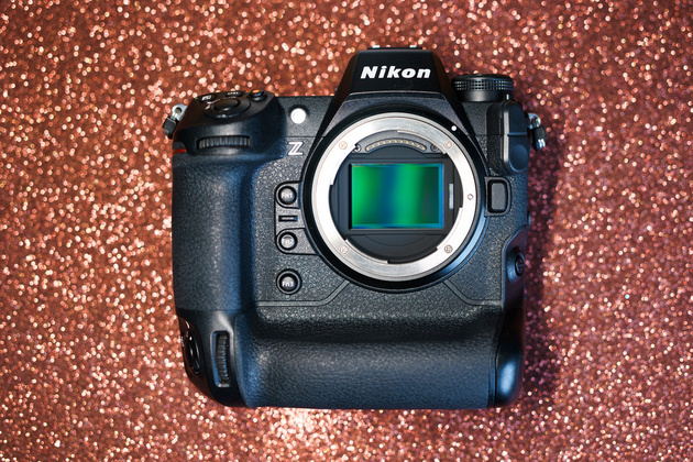 Nikon Z mirrorless body with a vertical grip and its full-frame sensor exposed, on a glittering background