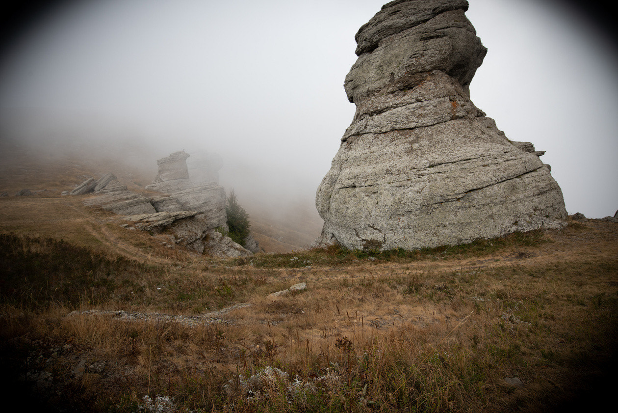 Rock formation in fog with dark vignetting in the corners of the frame
