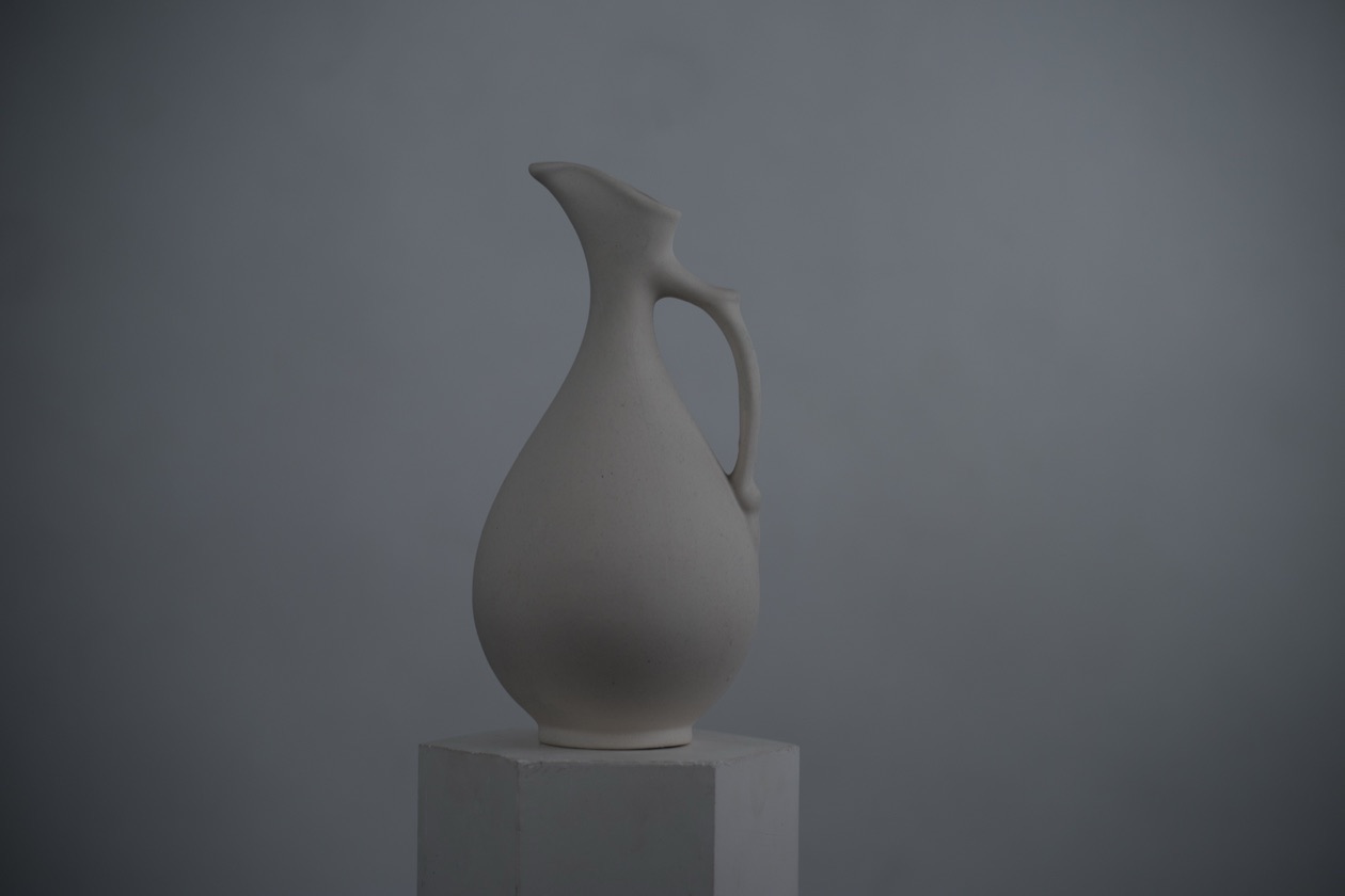 White ceramic jug on a white background, rendered dark gray by the meter