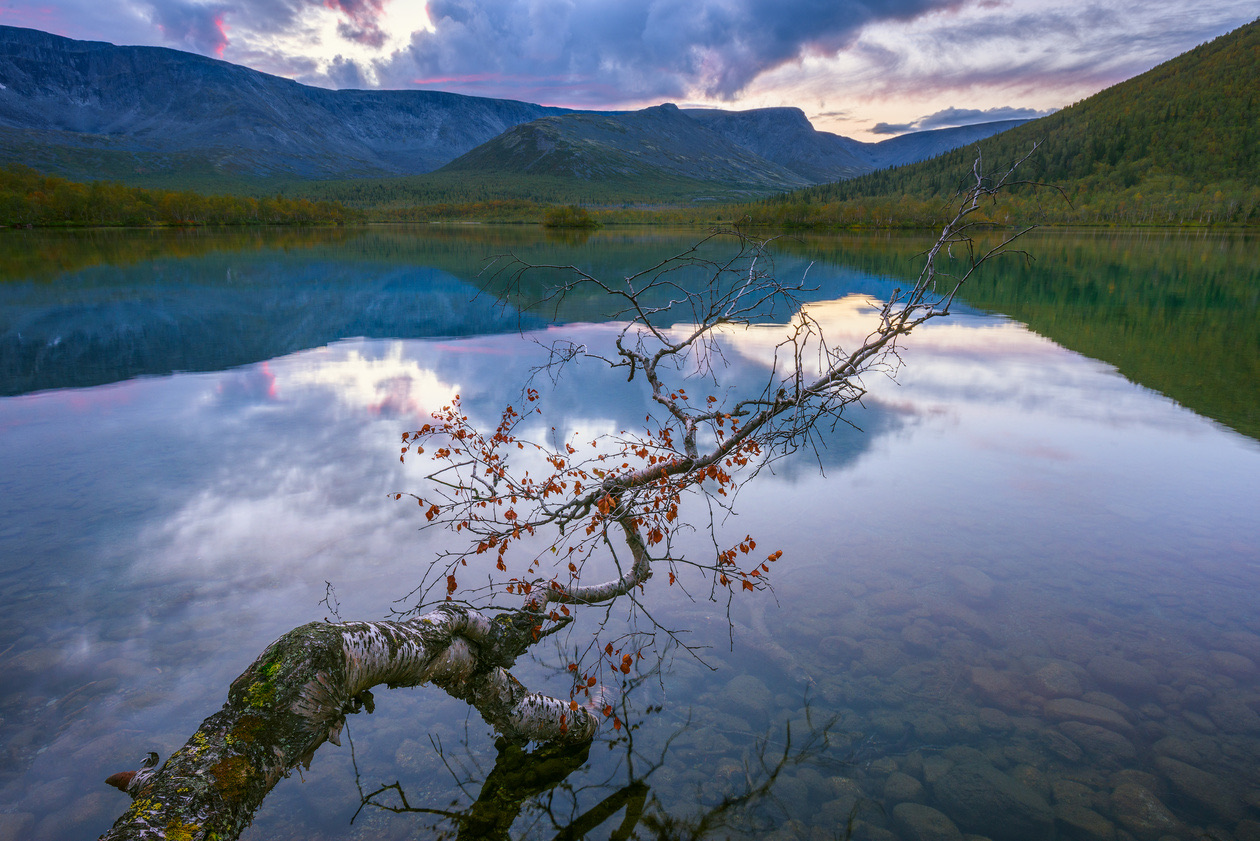 The same mountain lake with detail kept in the cloudy sky and the dark foreground