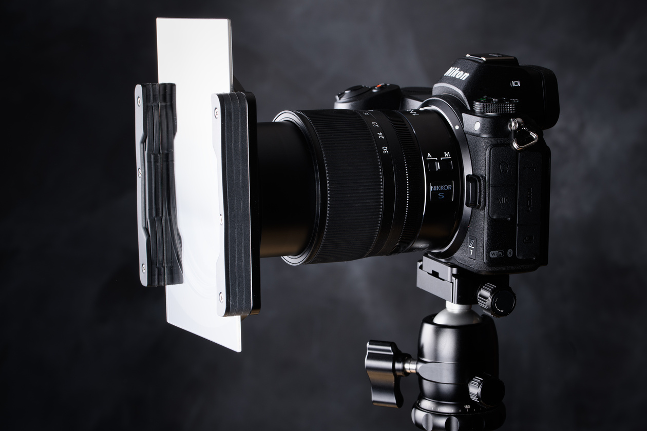 Nikon Z camera on a tripod with a 100 mm square filter in a holder on its lens