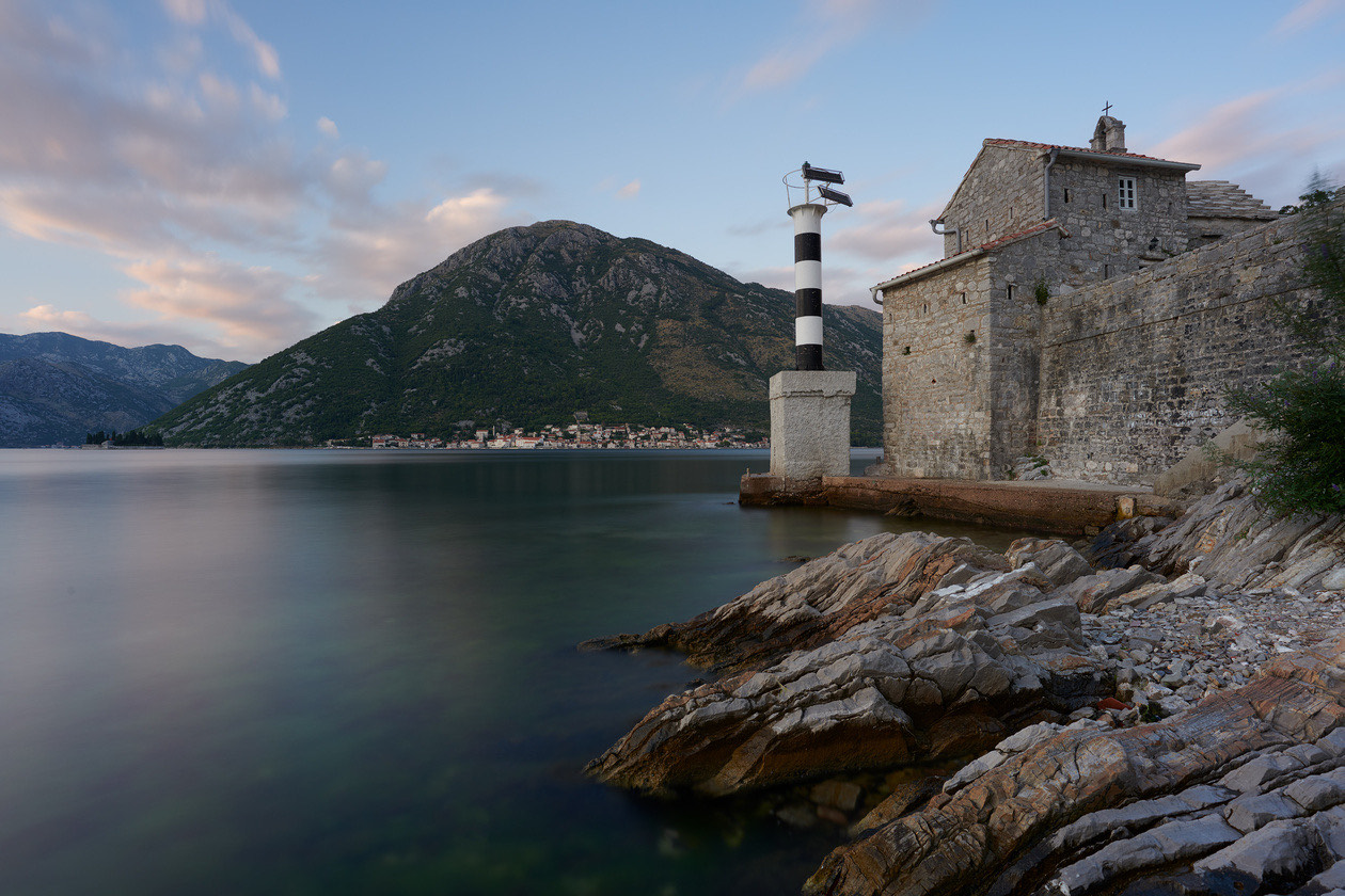 The same bay scene at a very long exposure, with glassy water and streaked clouds