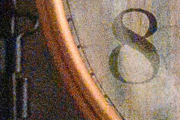 Crop of the alarm clock dial at maximum ISO, covered in grain and color speckles